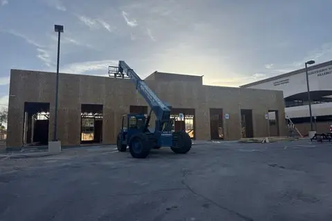 Sheathed exterior walls of The Industry Studios with a telehandler on site, Henderson NV