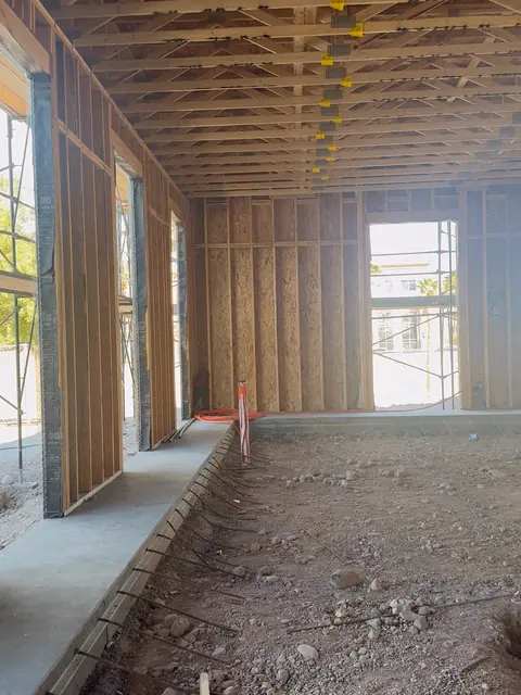 Interior of The Industry Studios shell with roof trusses installed, sheathed walls and framed window openings, Henderson NV, February 2026