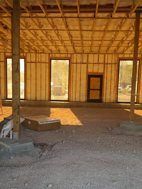 Insulation batts installed in the exterior walls of The Industry Studios over the dirt floor, Henderson NV, May 2026